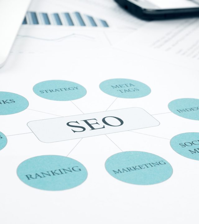 Seo business, search engine optimazion, concept flow chart. Pen, tablet touchped and smartphone on background. Blue Toned