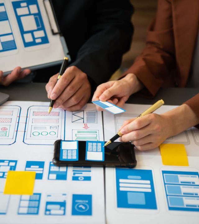 Asian businessman and woman people meeting in office. Employee brainstorm and work as team, plan and discuss project by point on paper and tablet.