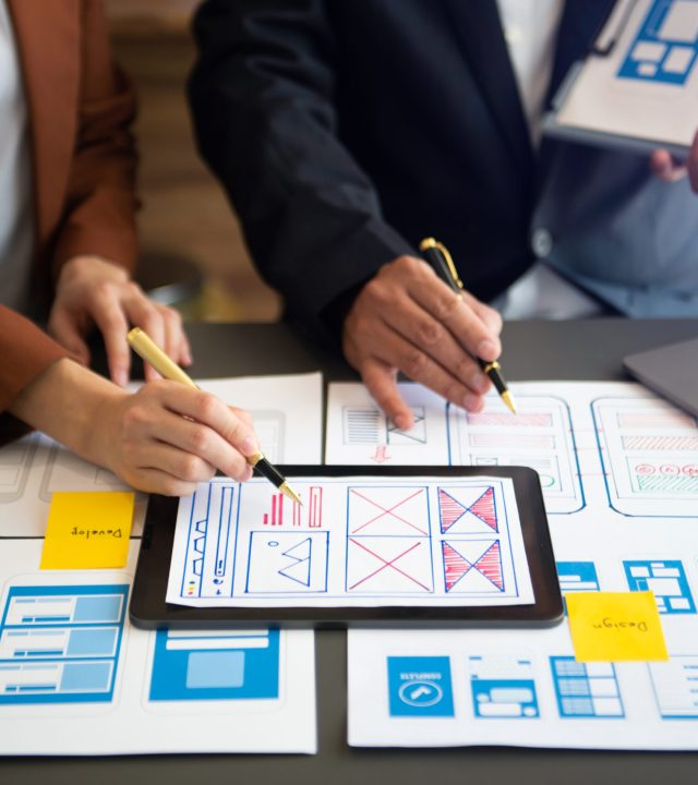 Asian businessman and woman people meeting in office. Employee brainstorm and work as team, plan and discuss project by point on paper and tablet.