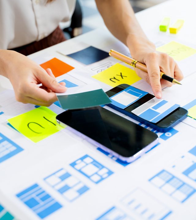 UX graphic designer planning application process development prototype wireframe for web smart phone. Creative digital development agency.
